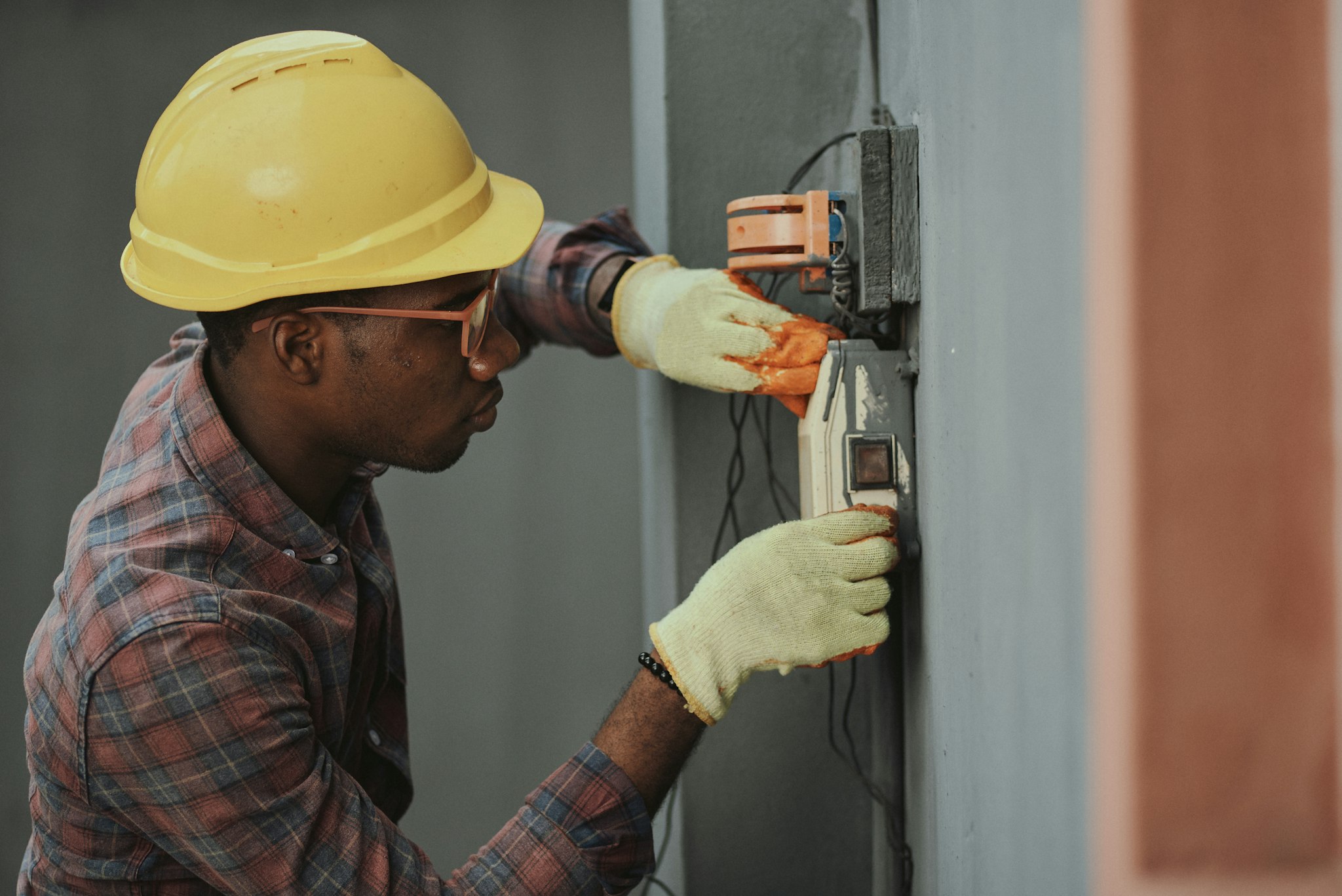 Alfa Electric engineer testing a consumer unit with a multimeter